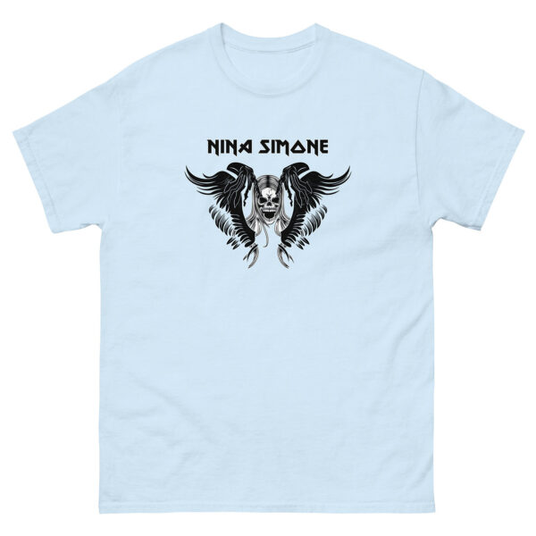 Pale blue t-shirt displaying a dramatic black-and-white graphic of a skull with feathered wings and long hair, topped by the artist name “Nina Simone.”