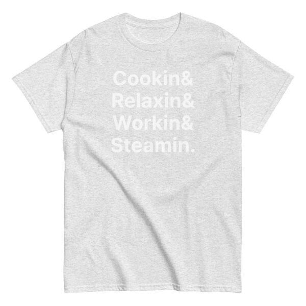 Heather gray t-shirt with faint white stacked text reading “Cookin& Relaxin& Workin& Steamin.” in bold sans-serif font.