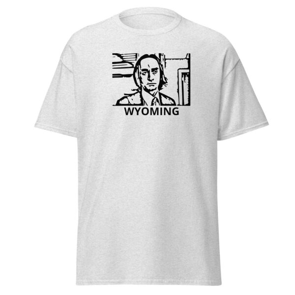 Light heather grey t-shirt showing a black block-print-style illustration of a serious man in a suit and tie within a rectangular border, with the word “WYOMING” centered below.