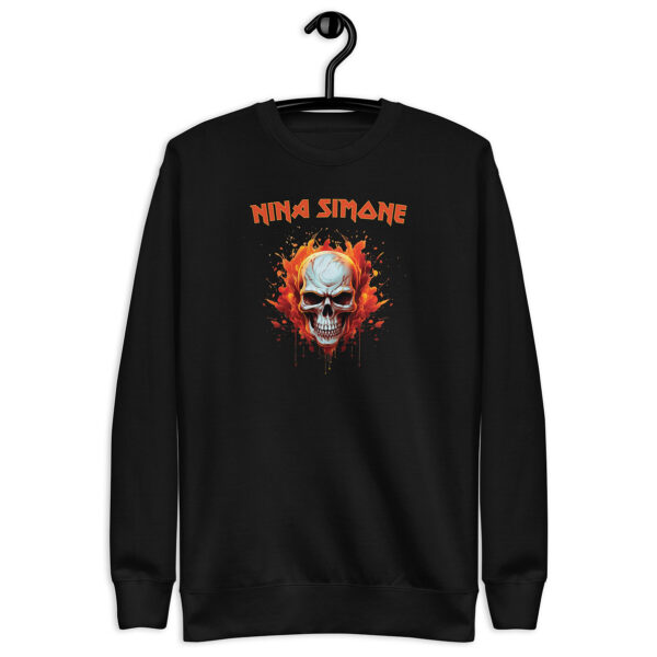 Black crewneck sweatshirt on hanger with a flaming skull graphic and the text “NINA SIMONE” in orange, in a bold, rock-style font.