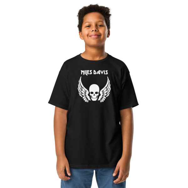 Front view of a black T-shirt with the same “Miles Davis” winged skull graphic, worn by the same child. Pose and expression are consistent with previous images.