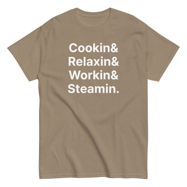 Tan t-shirt with large white stacked text reading “Cookin& Relaxin& Workin& Steamin.” in bold sans-serif font.