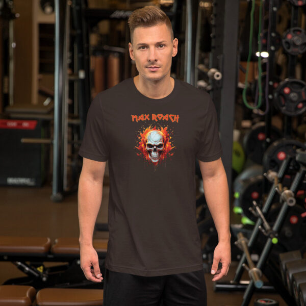 Man wearing a deep brown t-shirt with a graphic flaming skull and "Max Roach" title in red, posing in a gym.