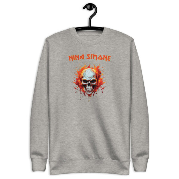 Light heather grey crewneck sweatshirt on hanger with a flaming skull graphic and the text “NINA SIMONE” in orange, in a bold, rock-style font.