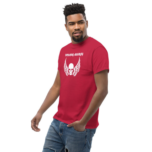 Man walking in a red t-shirt printed with a large white skull with wings and the text “CANNONBALL ADDERLEY” in stylized lettering.