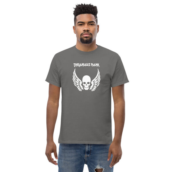 Alt text: Man in a gray t-shirt featuring a bold white skull with wings and “Thelonious Monk” printed above in a distressed typeface.