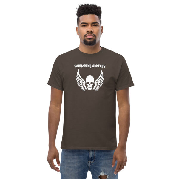 10. Front view of a man in a brown t-shirt featuring “CANNONBALL ADDERLEY” above a white skull with wings graphic.