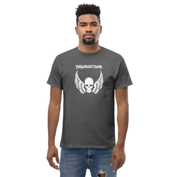 Man wearing a charcoal heather t-shirt with a centered white skull and wings design and “Thelonious Monk” above in bold uppercase letters.