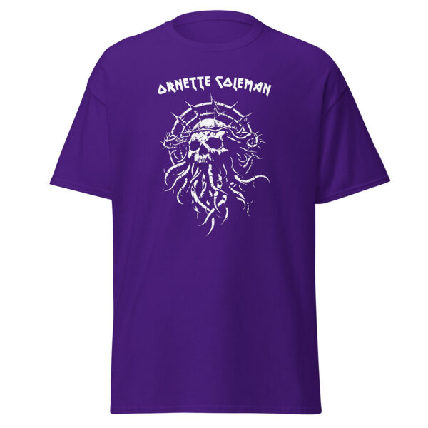 Unisex deep purple t-shirt showing a white skeletal skull encircled with thorny lines and curling roots, positioned below the name “Ornette Coleman” in stylized text.