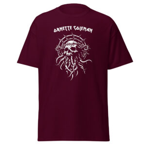 Unisex maroon t-shirt featuring a stark white graphic of a thorn-wrapped skull with curling tentacles beneath the name “Ornette Coleman” in stylized lettering.