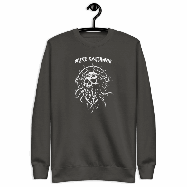 Charcoal crewneck sweatshirt on a hanger, featuring a white distressed-style illustration of a skull with barbed halo and vine-like tendrils. The upper chest reads “ALICE COLTRANE” in jagged white type.