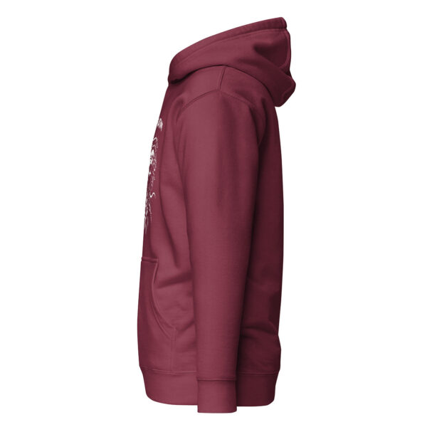 Side view of maroon unisex pullover hoodie showing kangaroo pocket and partial edge of white graphic design on front.
