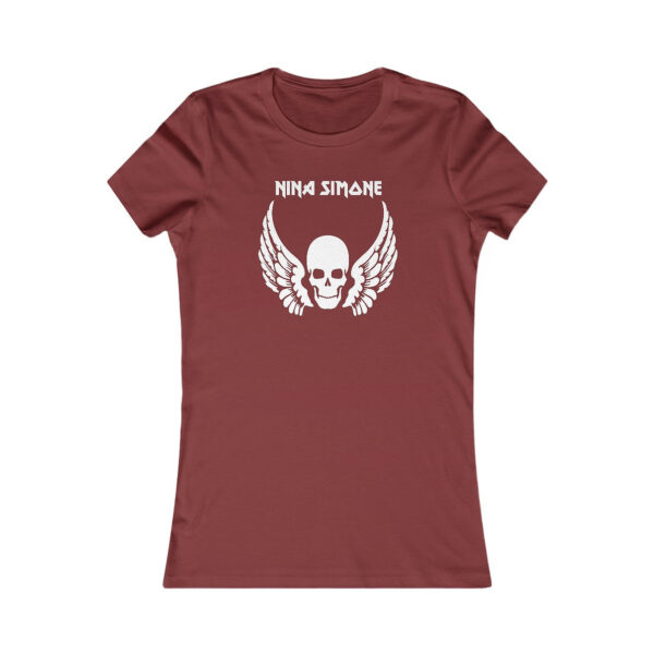 Flat lay of a maroon women's fitted t-shirt printed with a white skull with wings and the name “NINA SIMONE” in uppercase above it, in a bold stylized font.