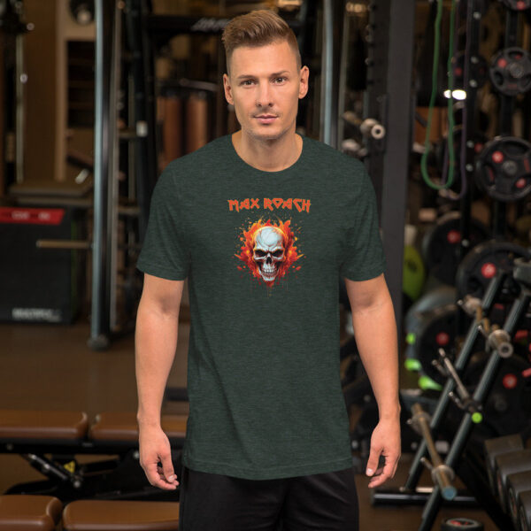 Man in a dark heather green t-shirt displaying a flaming skull and "Max Roach" text in red, inside a gym.