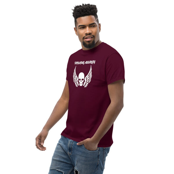 Man wearing a maroon t-shirt with a white skull with wings graphic and "Cannonball Adderley" text on the chest.