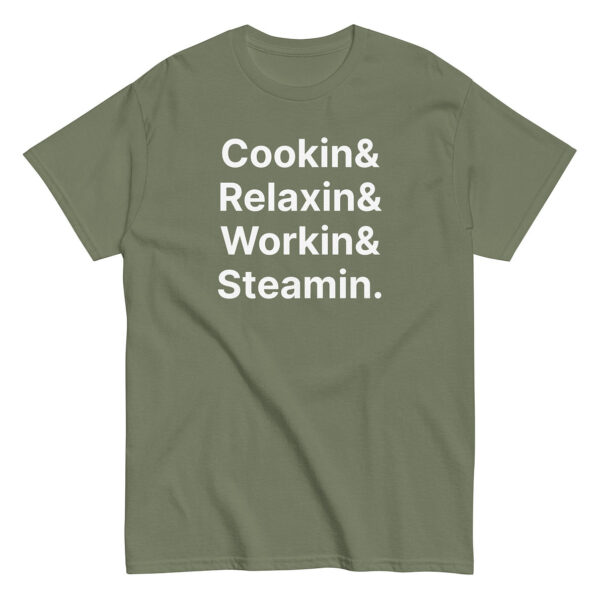 Olive green t-shirt with large white text stacked in four lines: “Cookin& / Relaxin& / Workin& / Steamin.”
