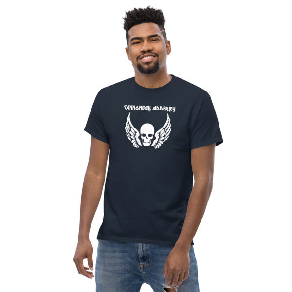 Man smiling in a navy t-shirt that displays a white skull with wings and "Cannonball Adderley" lettering.