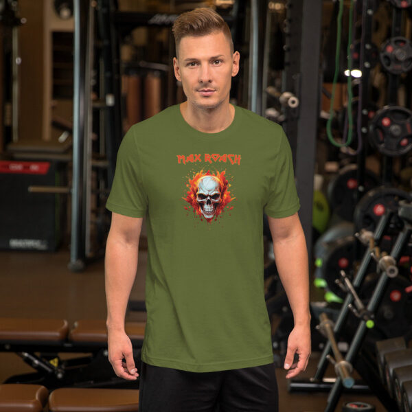 Man in an olive green t-shirt with fiery skull artwork and red "Max Roach" text, posing in a gym environment.