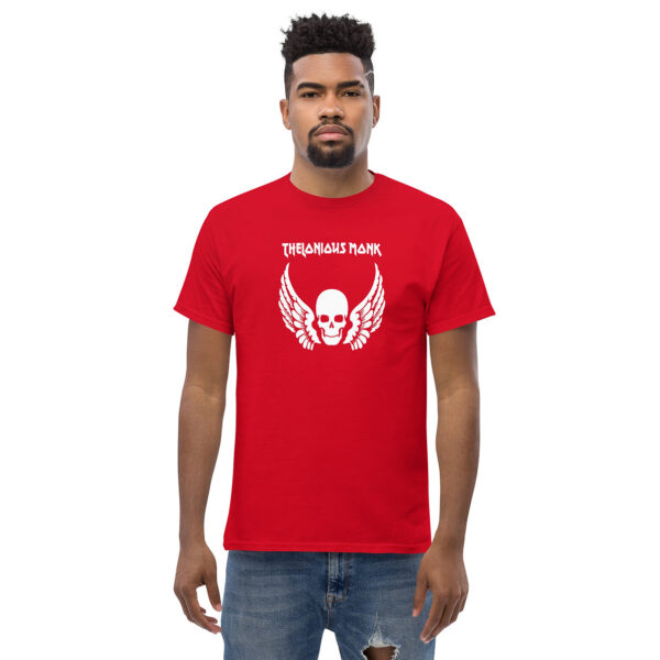 Man wearing a bold red t-shirt with a white skull and wings centered on the chest and “Thelonious Monk” written above in bold lettering.