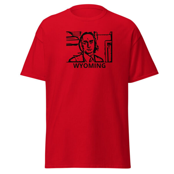 Bright red t-shirt with a stark black graphic of a man’s portrait in a rectangular frame, wearing a suit and tie. The word “WYOMING” appears beneath in bold sans-serif type.