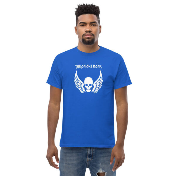 Man in a vibrant blue t-shirt with a white skull and wings graphic and the name “Thelonious Monk” printed in bold typeface above.