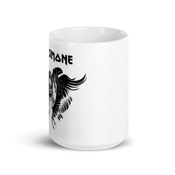 White ceramic mug, partial side view, showing winged skull with long hair and text “Nina Simone” in metal-style font