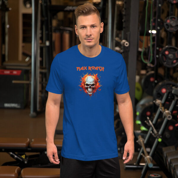 A man standing in a gym wearing a royal blue t-shirt with a vivid graphic of a flaming skull and red splashes, with “Max Roach” written in red stylized font above.