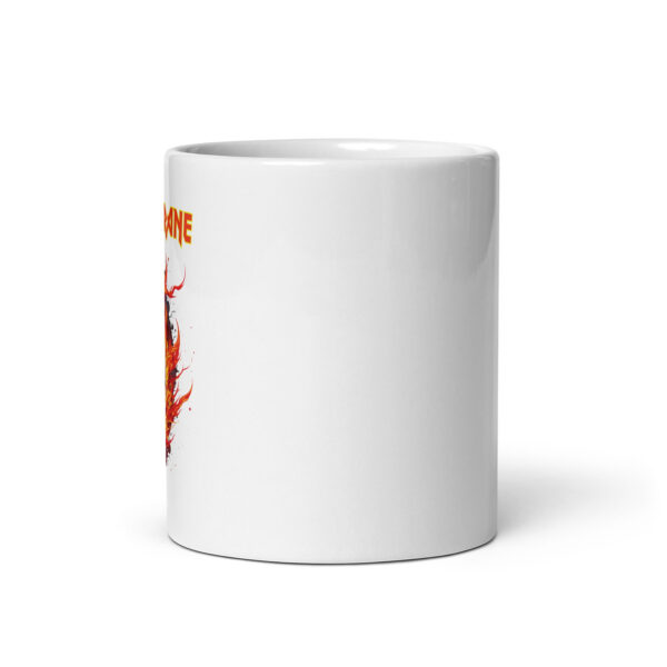 Side view of a white ceramic mug with partial view of a fiery skull illustration and the beginning of the text “Alice Coltrane” in bold red-and-yellow font, placed toward the left edge.