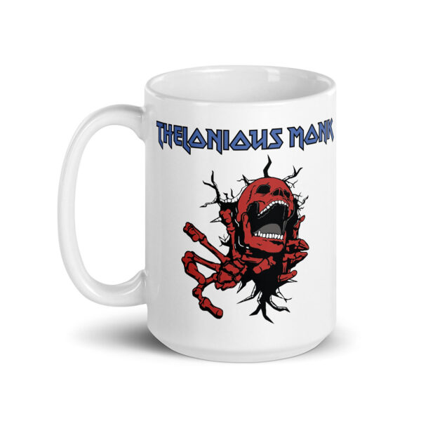 White ceramic mug featuring a graphic of a screaming red skeleton bursting through a wall, with the text "Thelonious Monk" in bold, blue heavy-metal style font above the image.