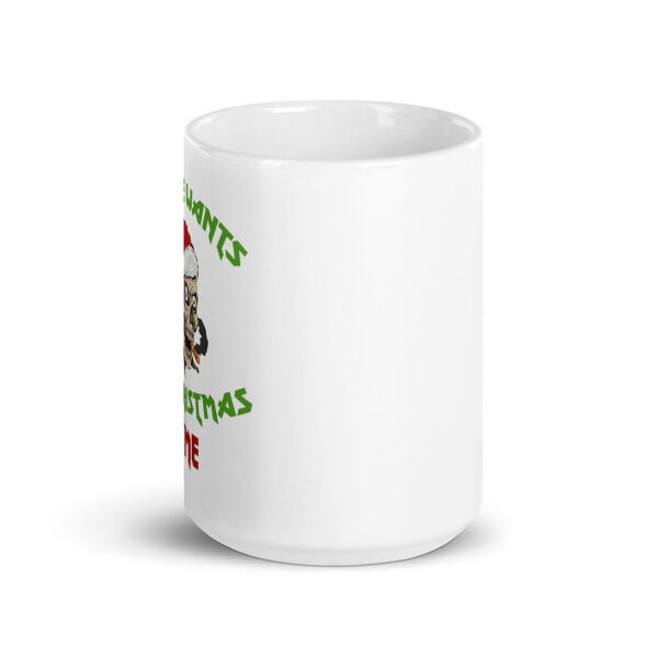 White ceramic mug with partial view of a cartoon zombie wearing a Santa hat and green jagged text that appears to be holiday-themed, wrapping around the character.
