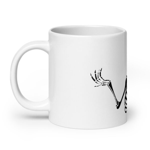 White ceramic mug with a black illustration of a skeleton's arm and hand extended across the side. The skeletal hand is raised with fingers spread in a playful gesture. The design is minimalistic, wrapping from the front of the mug to the side, using stark black linework against the white surface for a high-contrast effect.