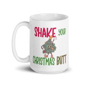 White ceramic mug with a festive design featuring a dancing cartoon Christmas tree and the phrase “SHAKE YOUR CHRISTMAS BUTT” in bold red and green lettering.