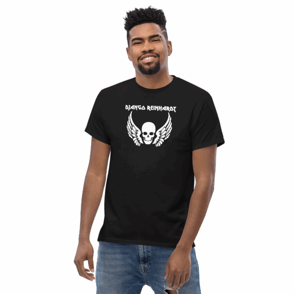 Django Reinhardt tribute t-shirt in black, featuring a white winged skull graphic and bold uppercase name text, modeled at a slight angle, smiling.