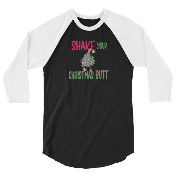 Black and white raglan sleeve shirt featuring the text "Shake Your Christmas Butt" with a cartoon Christmas tree character dancing in the center.