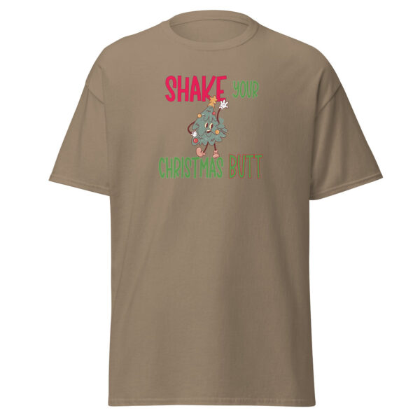 Brown short-sleeve t-shirt featuring a festive cartoon Christmas tree with arms raised and ornaments, paired with the playful holiday phrase "Shake Your Christmas Butt" in bold red, green, and brown lettering.