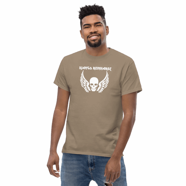 Django Reinhardt tribute t-shirt in sand beige, featuring a white winged skull graphic and bold uppercase name text, modeled at a slight angle, smiling.