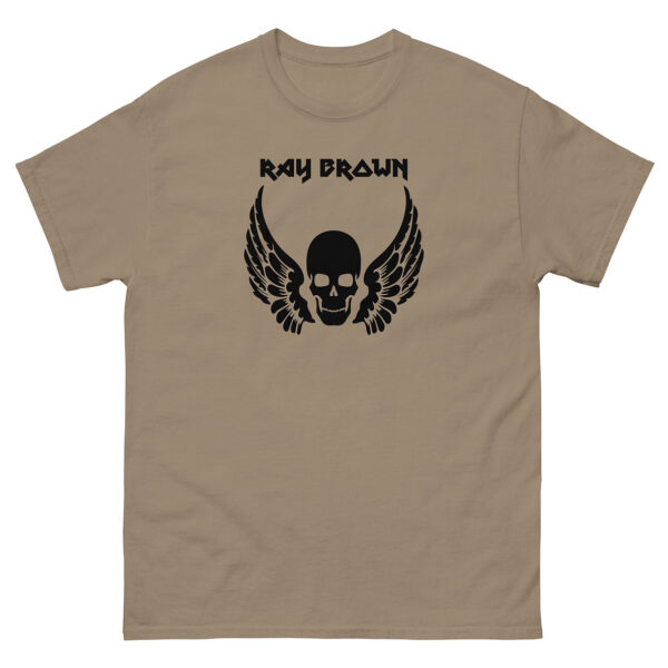 Tan t-shirt featuring a black skull with wings and "Ray Brown" text in bold gothic font above the graphic, centered on the chest.