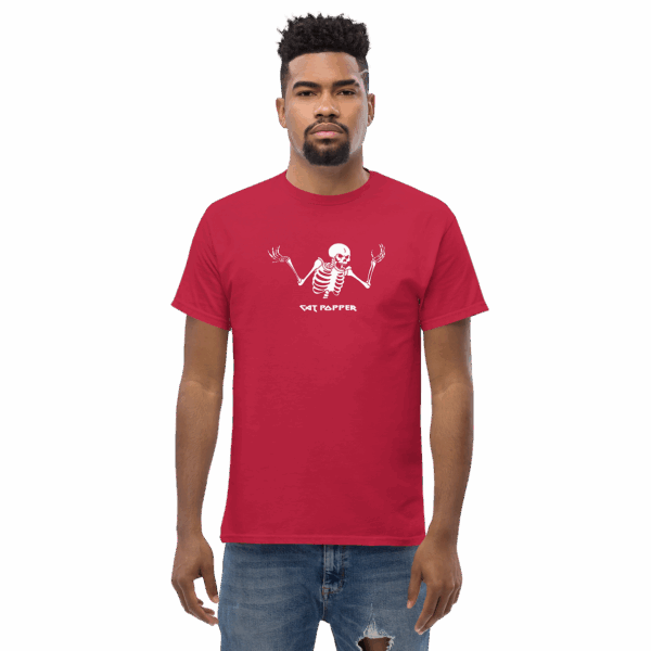 Man standing straight in a red t-shirt featuring a centered white skeleton graphic and the text "CAT POPPER" across the chest.