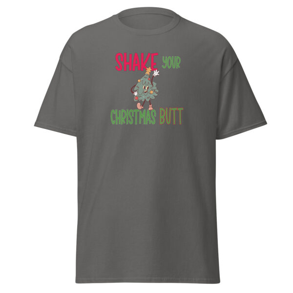 Gray short-sleeve t-shirt featuring a playful holiday design with the phrase "Shake Your Christmas Butt" in festive red, green, and brown text, surrounding a cartoon Christmas tree character dancing with ornaments and a star on top.