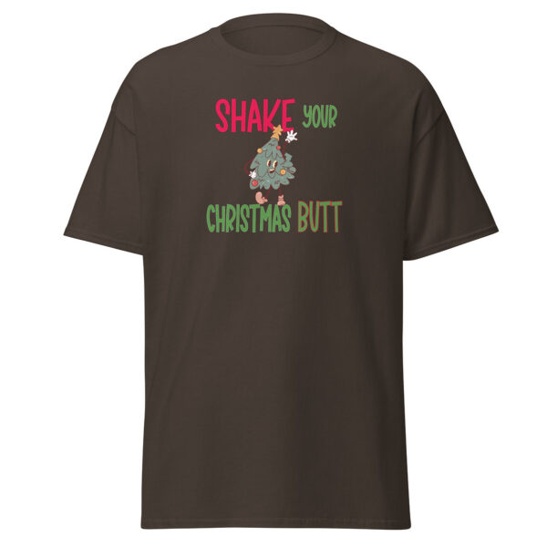 Dark brown short-sleeve t-shirt featuring a humorous holiday graphic with the phrase "Shake Your Christmas Butt" in red, green, and brown text, centered around a cartoon Christmas tree character shaking its hips.