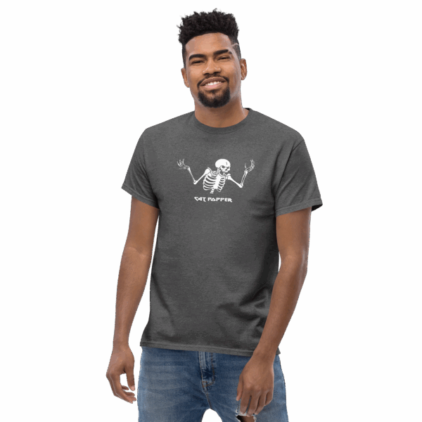 Man wearing a dark heather gray t-shirt with a white skeleton graphic and the text “Cat Popper,” posing casually with a slight smile.
