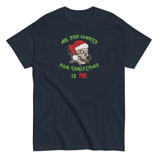 Navy blue unisex T-shirt featuring a graphic of a smoking skull wearing a red Santa hat. Surrounding the illustration is festive text in green and red that reads “All She Wants for Christmas Is Me.”