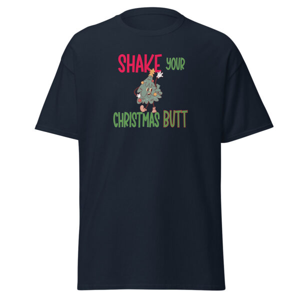 Black short-sleeve t-shirt with a playful holiday design that reads "Shake Your Christmas Butt" in red, green, and brown text, featuring a dancing cartoon Christmas tree character at the center.