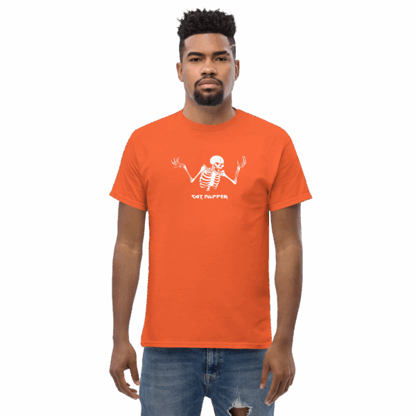 Man wearing a bright orange T-shirt with a white skeleton graphic and the text "CAT POPPER" centered on the chest. He is standing upright, facing forward with a neutral expression. The background is transparent.