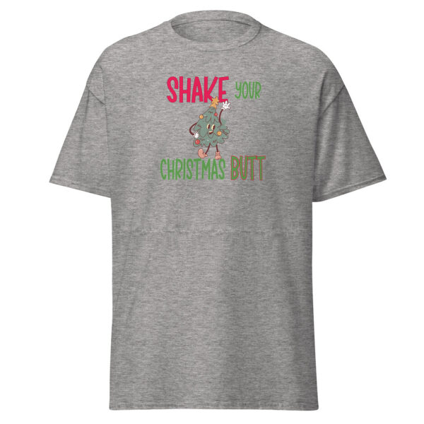 Heather gray short-sleeve t-shirt featuring the phrase "Shake Your Christmas Butt" in festive red, green, and brown lettering, with a playful cartoon Christmas tree character dancing in the center.