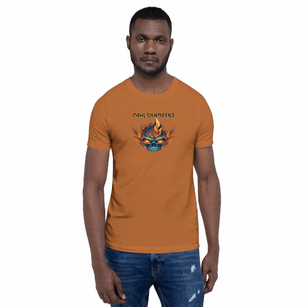 Man in a straight stance wearing an orange-brown t-shirt with a vibrant flaming skull graphic and “Paul Chambers” text.