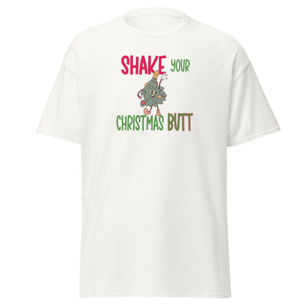 White short-sleeve t-shirt with the phrase "Shake Your Christmas Butt" in red, green, and brown text, featuring a cartoon dancing Christmas tree character in the center.