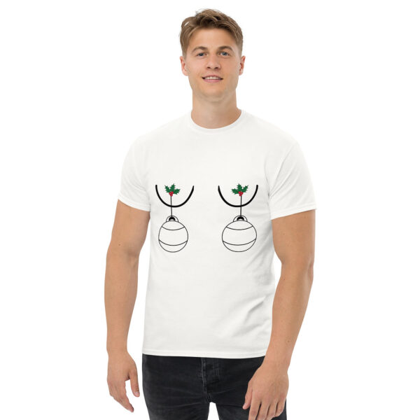 Man wearing a white T-shirt with a humorous holiday design featuring two Christmas ornaments hanging from holly sprigs positioned over the chest.