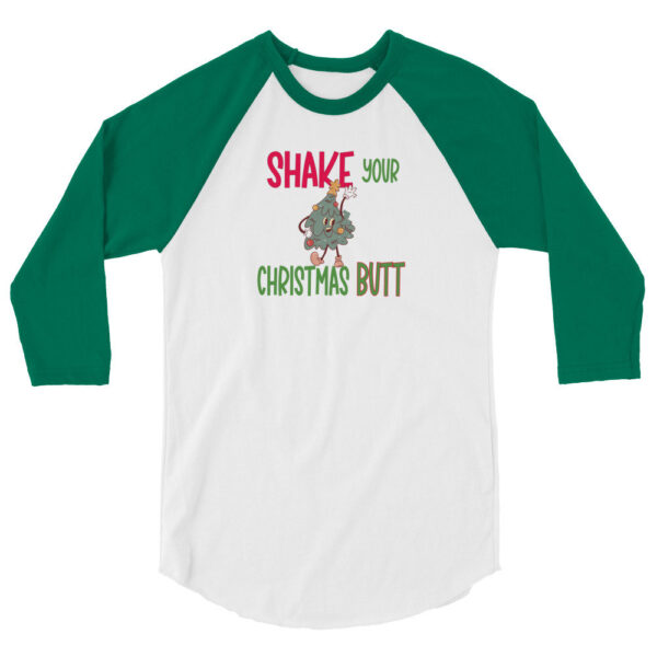 White and green raglan sleeve shirt featuring the text "Shake Your Christmas Butt" with a cartoon Christmas tree character dancing in the center.